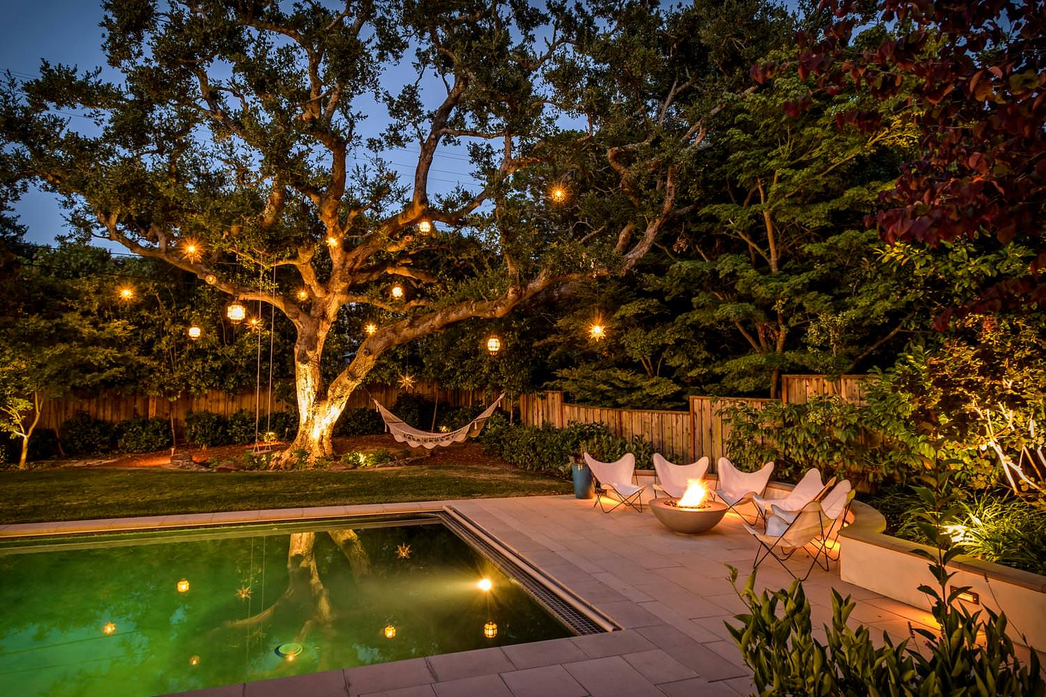 Pool and garden with warm evening lighting