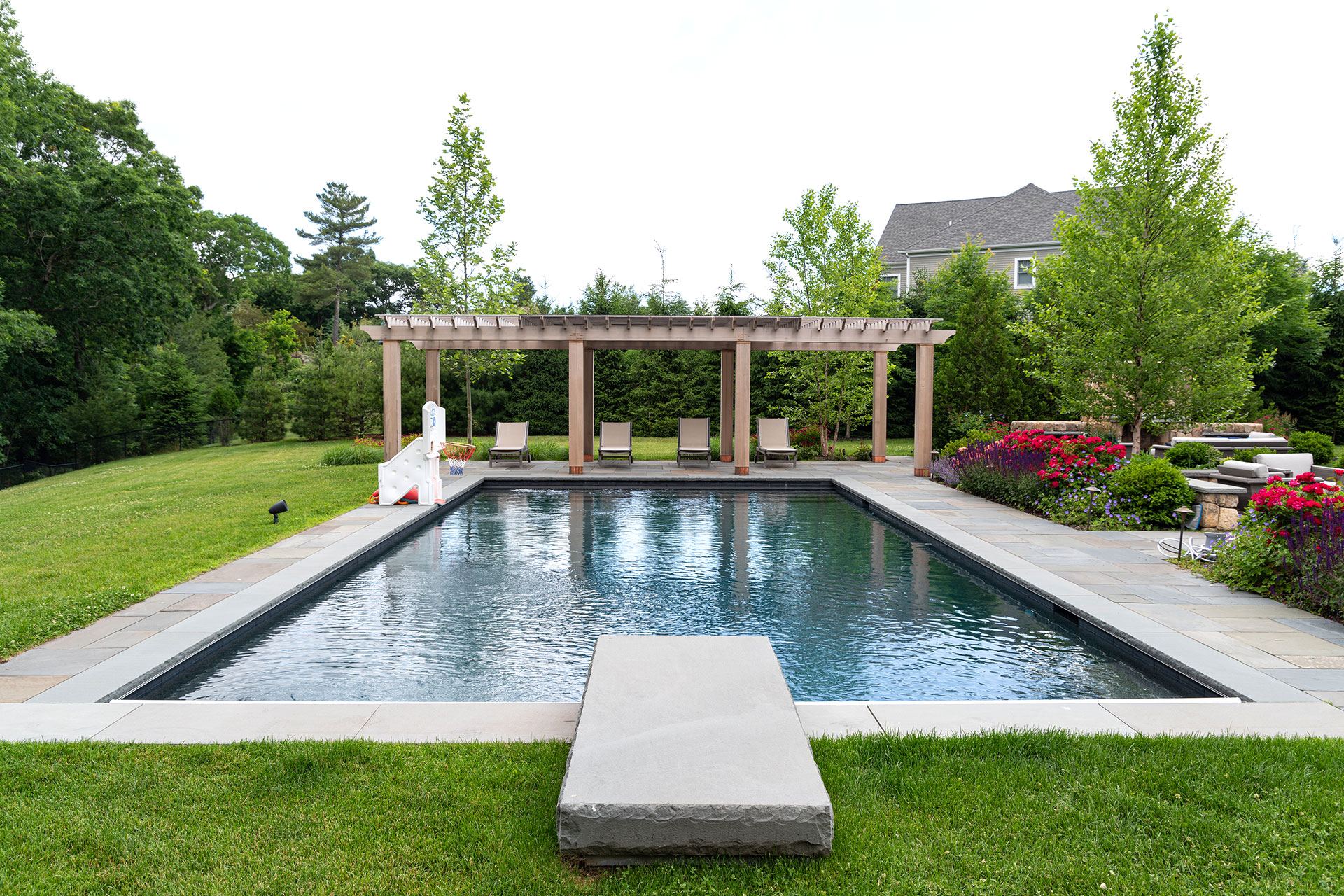 Residential pool with mature deciduous trees in summer