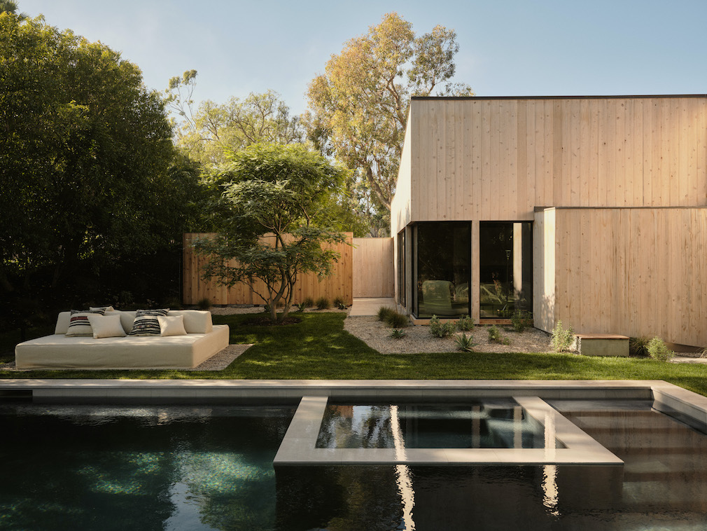 Stone edge and planted transition beside a residential pool