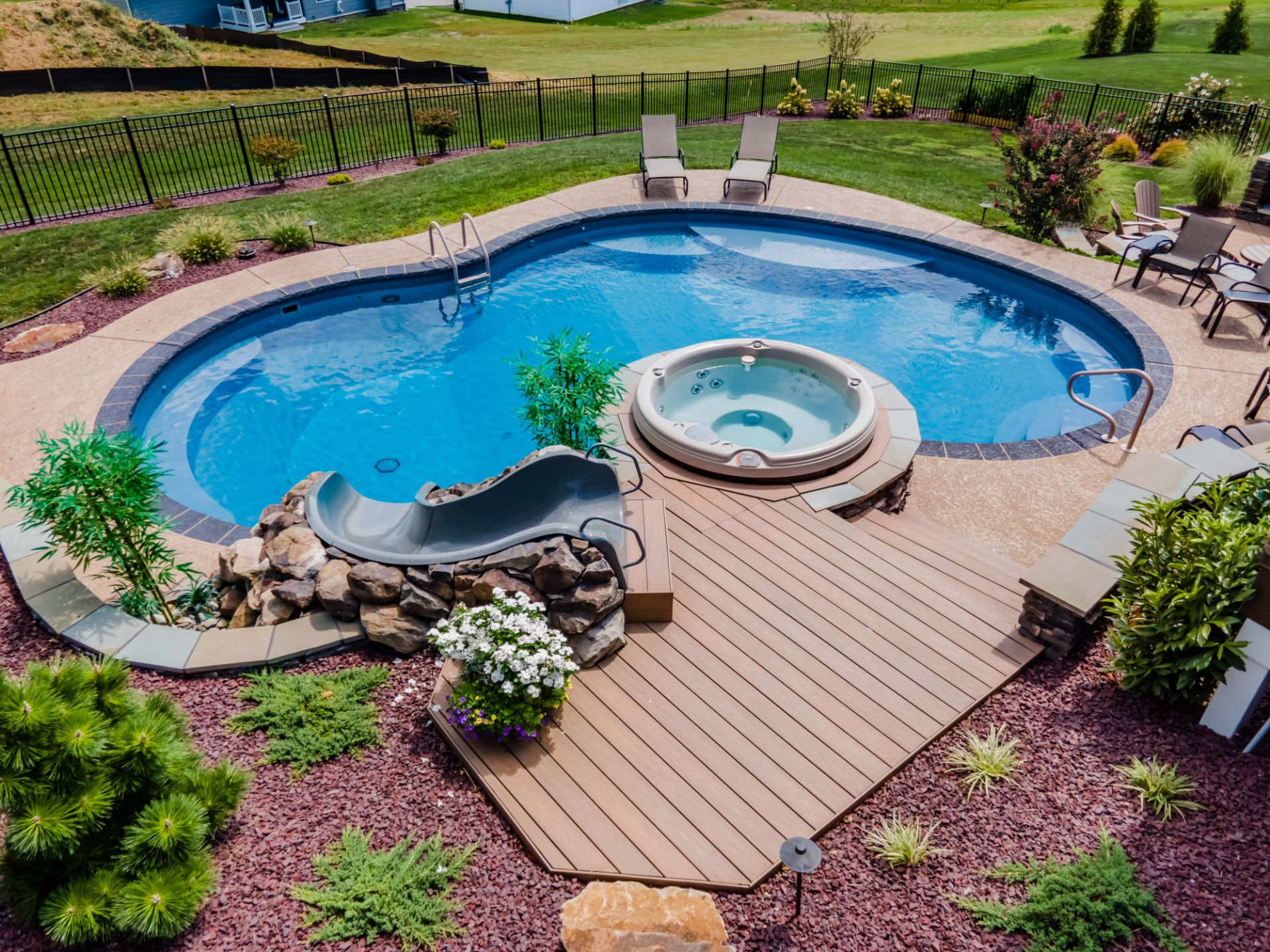 Vinyl Liner custom inground pool in a mature residential backyard